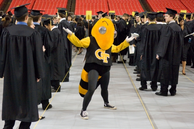 Buzz with students dressed in caps and gowns.