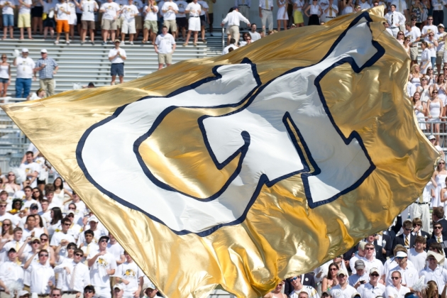 GT big banner with a football crowd behind.