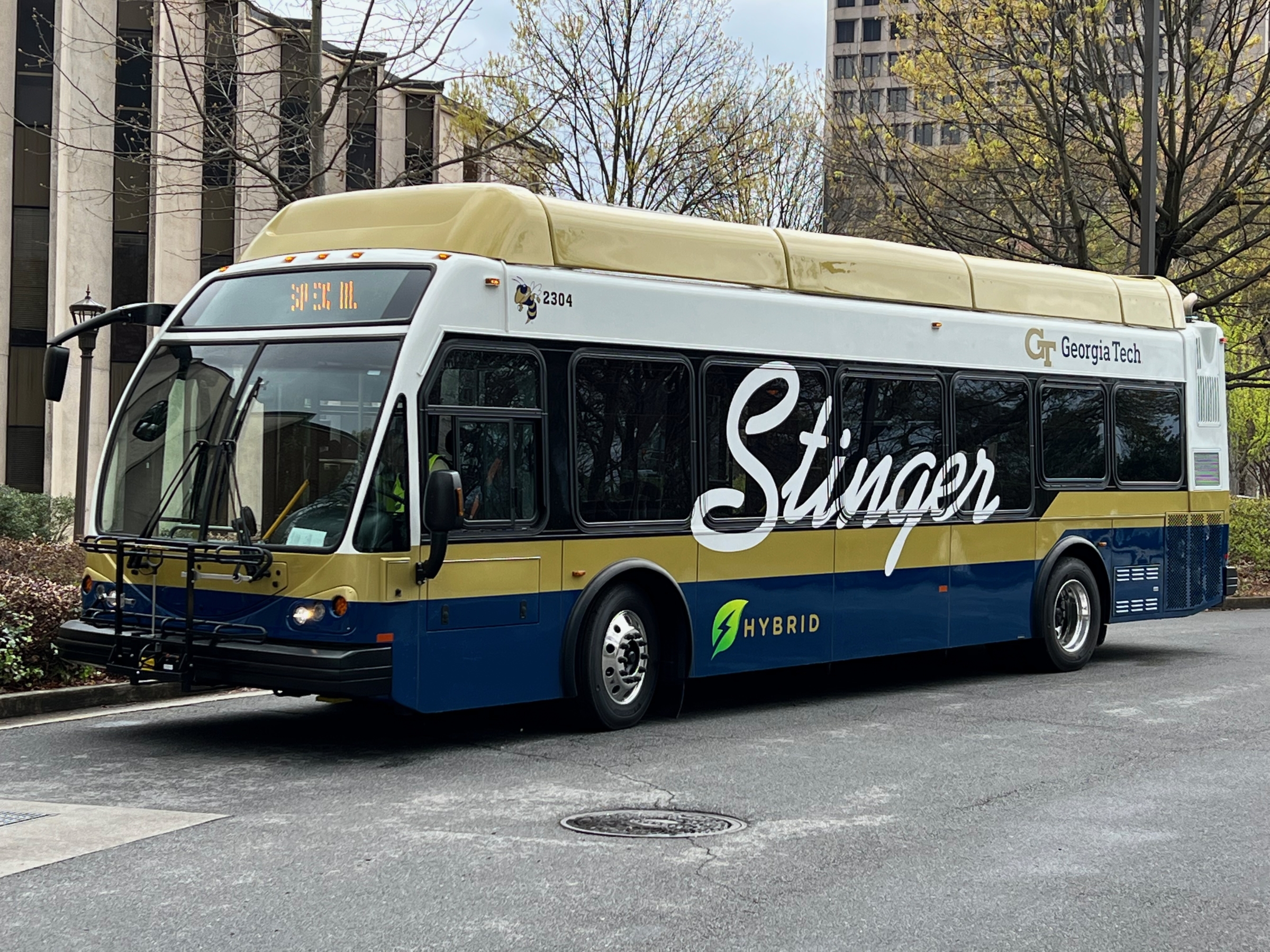 A navy and gold colored bus with the word Stinger