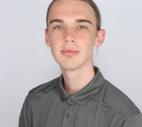 student in gray professional polo
